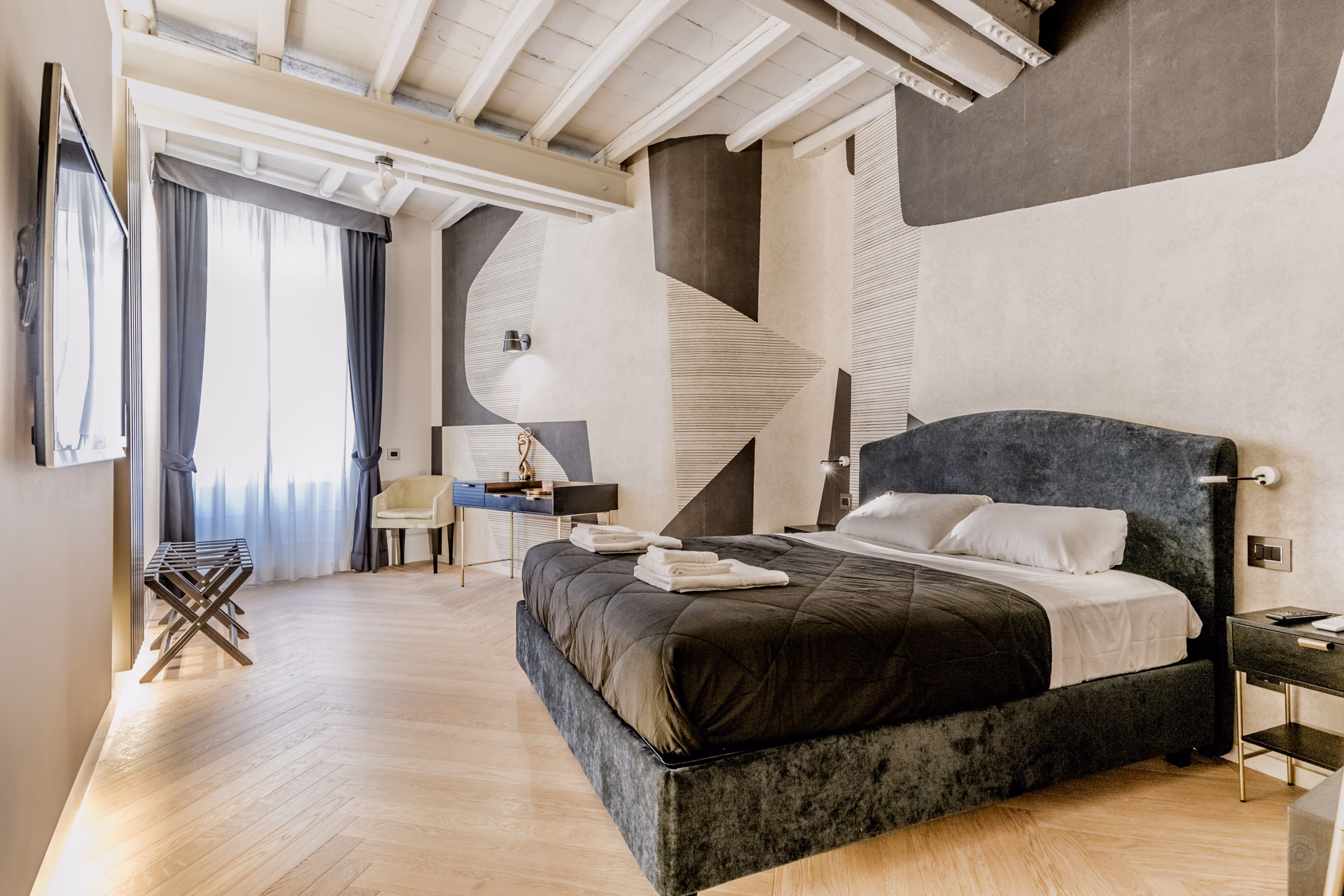 Bedroom with beamed ceiling in the Spanish Steps luxury design loft, Rome